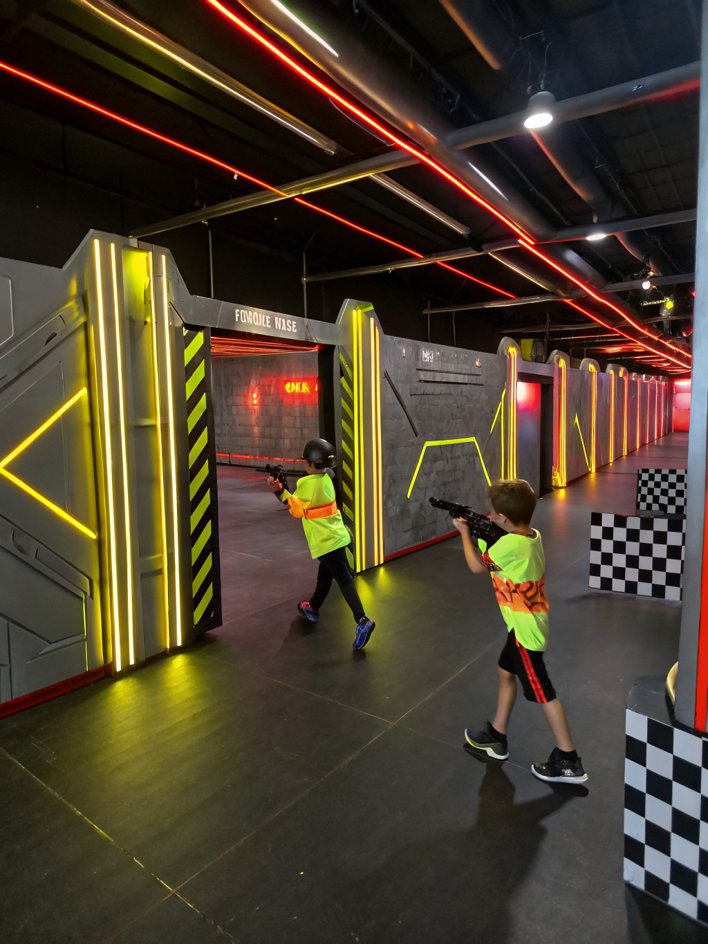 Children celebrating birthday party during high-energy laser tag match